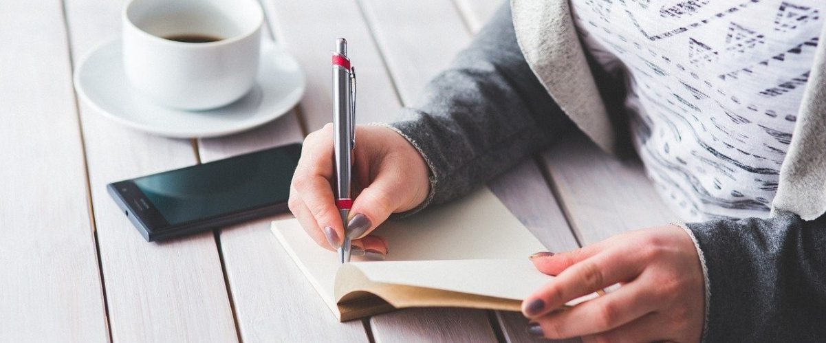 Woman writing in a notebook