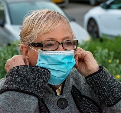 an elderly woman wearing a face mask