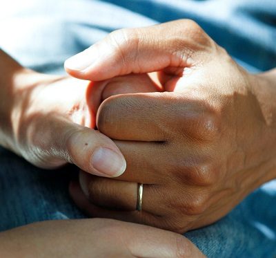 two people holding hands while providing cancer care